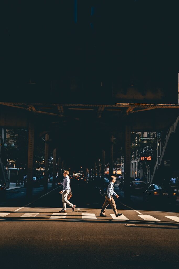 two man crossing at pedestrian lane